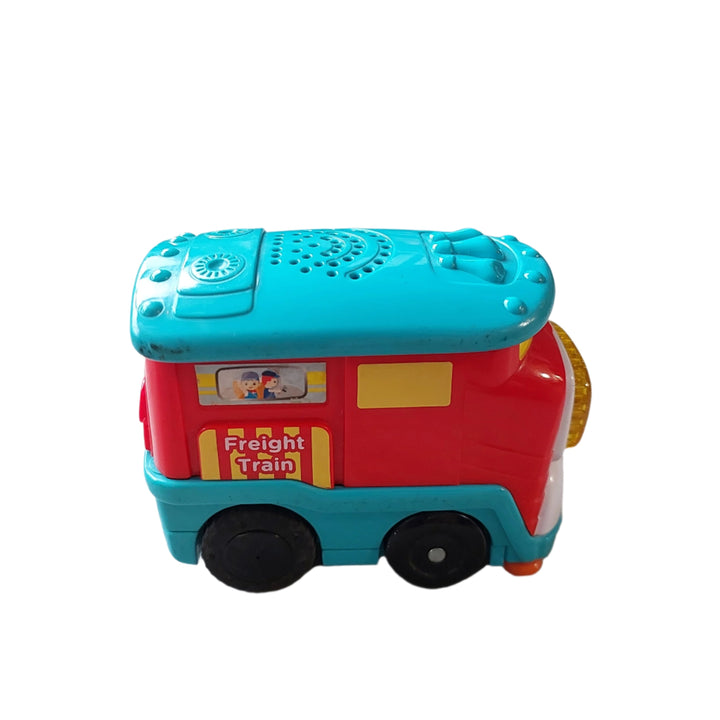 Vtech, Freight Train, Fred the motorized Go! Go! Smart Wheels Freight Train by VTech loves chugging along with heavy cargo. Your little conductor can press the light-up button to hear sing-along songs and learn the letter “F” or push him along to play cheerful melodies and sound effects. Pretend to fill up the detachable tanker car by spinning the tanker's drum to develop motor skills. This cute little train also responds to SmartPoint locations on Go! Go! Smart Wheels playsets (sold separately) with fun ph