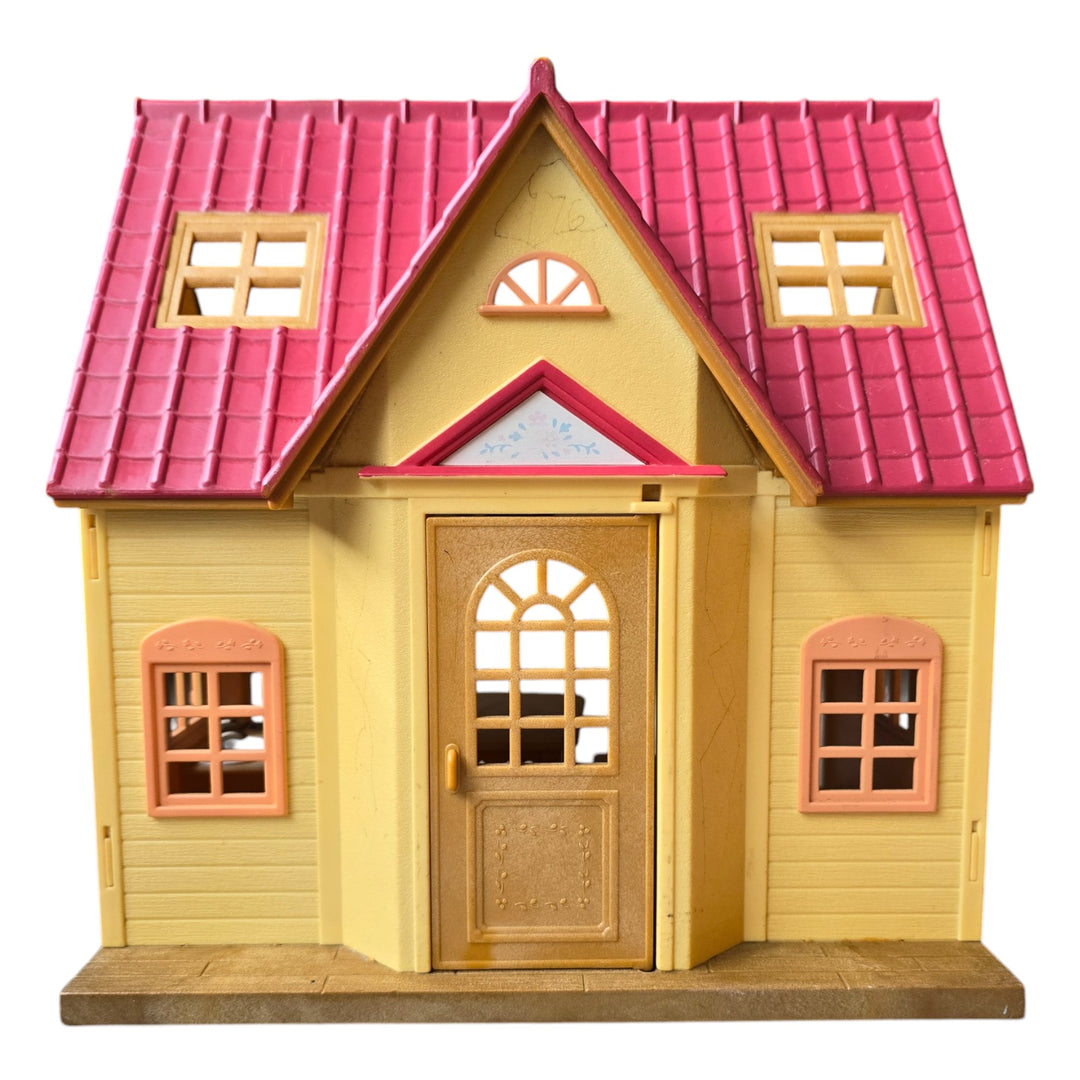 Sylvanian Families, The Cosy Cottage is the perfect choice those starting out with Sylvanian Families. With its red roof and beige brick style exterior, this quaint two floor cottage includes a ladder to connect the upstairs and downstairs.