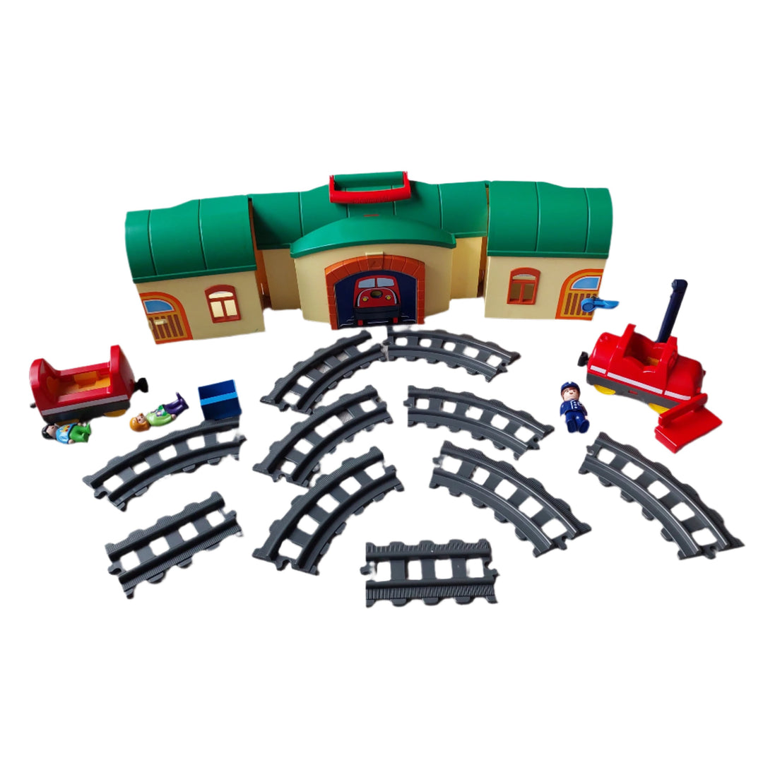 Playmobil, 6783 Take Along Train Set, All aboard! Cruise down the tracks on the My Take Along Train, With a bright and colorful design and large, rounded pieces, this Playmobil 1.2.3 set is ideal for toddlers, Train station doubles as a carrying case, making it the perfect set for toddlers on the go, Simply unlatch the side to reveal storage space for the three figures, two train cars, tracks, bench, suitcase, and traffic sign, Encourages children to explore and learn while having fun.