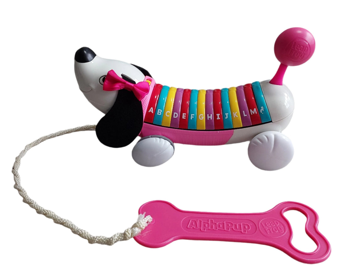 LeapFrog, Alphapup (Pink), Experience the ABC's with your new best friend! Alpha Pup is the perfect learning companion, walking and talking the ABC's with your child. Alpha Pup sounds out each letter and introduces letter names, words that begin with each letter and darling doggie phrases.