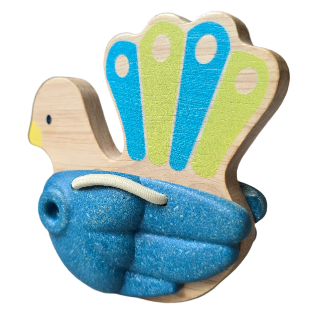 PlanToys, Toddlers will love to make some noise with this pretty peacock clapper toy. Hold onto the wooden handle and shake the clapper to make a clacking sound. This percussion instrument is made from solid rubberwood and Planwood, an eco product made from recycled rubberwood sawdust.