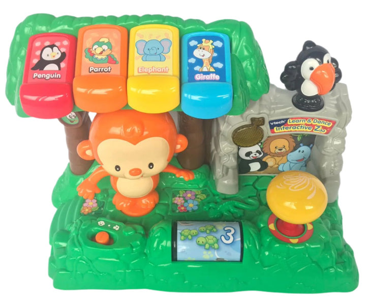 Vtech, Learn and dance interactive zoo, Go on an exciting zoo adventure with the Learn and Dance Interactive Zoo by VTech. This interactive playset for toddlers features a friendly monkey, a singing toucan and other favorite zoo animals. Press the colorful piano keys to learn about colors and animal names through fun songs and sounds. Move the joystick to make the monkey swing his arms, twist his body and turn his head, or spin the roller to meet some turtles. Playful songs will get you moving like the anim