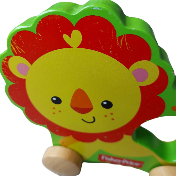 Fisher Price, My First Lion On Wheels, A wooden rolling lion pulled with string, this little lion on wheels is made of solid wood. For ages 12 months and above.