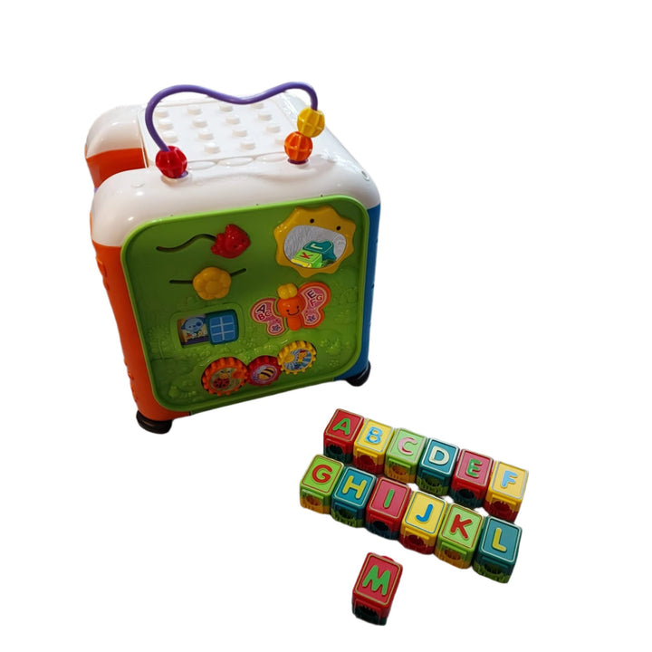 Vtech, Alphabet Activity Cube, The Alphabet Activity Cube by VTech is an interactive learning cube that has five sides of fun to discover! Little builders will love the 13 building blocks that also teach the alphabet. The blocks can be stacked on the top of the cube or they can be inserted into the slot on the electronic side to learn more about each letter. The electronic side also features five piano keys, a number keypad, and telephone. Other sides of this electronic learning toy feature fun mechanical e