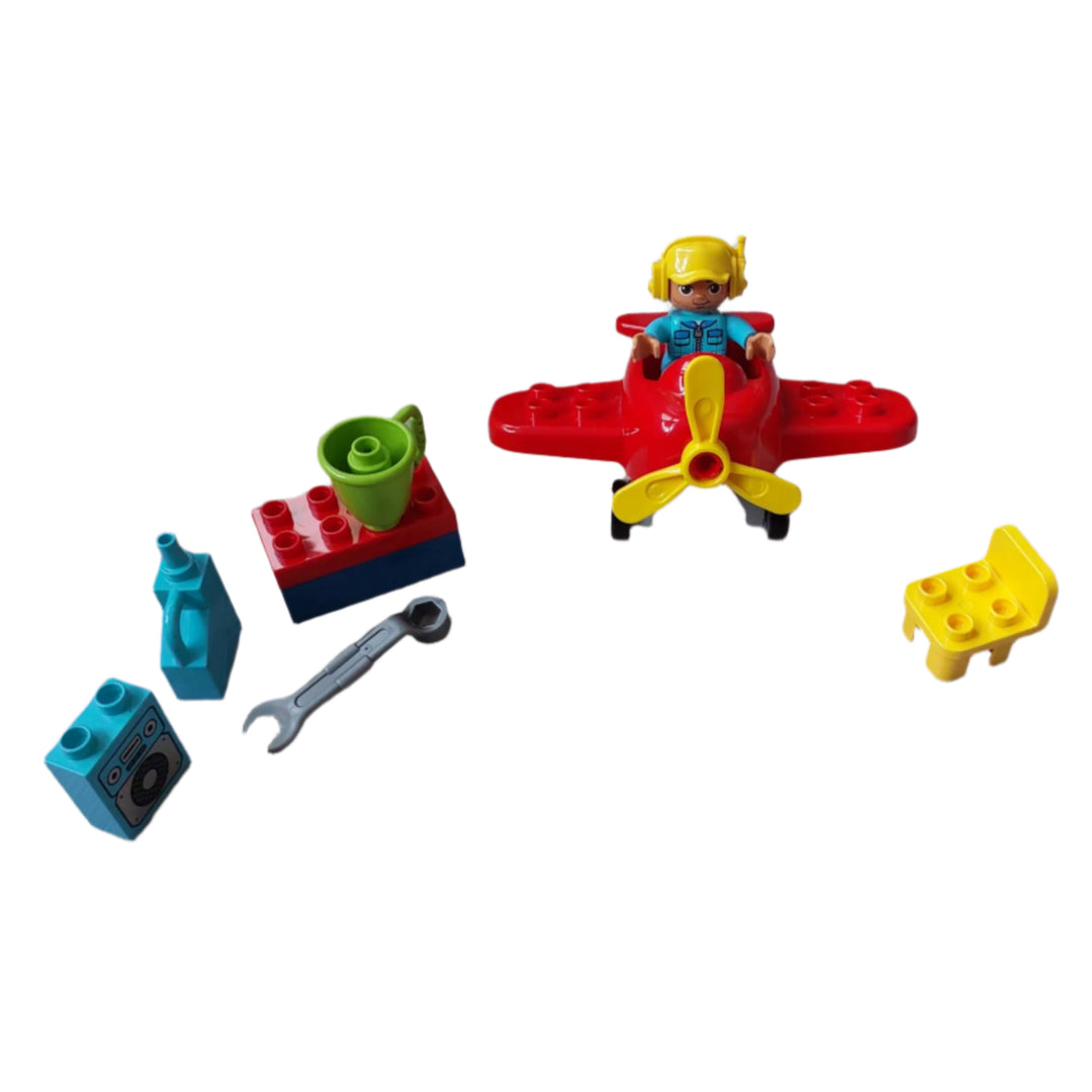 Lego, Town Plane (10908), Build a little workshop and use the tools to fix up the cute red propeller plane toddler toy! This toy airplane for kids includes a LEGO DUPLO pilot figure, workshop table and chair, oilcan, wrench, mug and a radio.