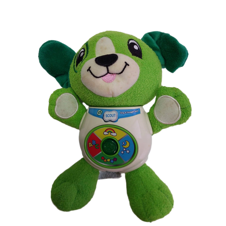 Leap Frog, Sing & Snuggle Scout, Your favorite friend is ready for learning on the go. Sing & snuggle Scout is a plush interactive puppy that talks and sings. Press the light-up button in the middle of his tummy to hear Scout bark and tell you how much he loves you. Then, press the colorful buttons to hear lullabies and learning songs about shapes, colors and letters.