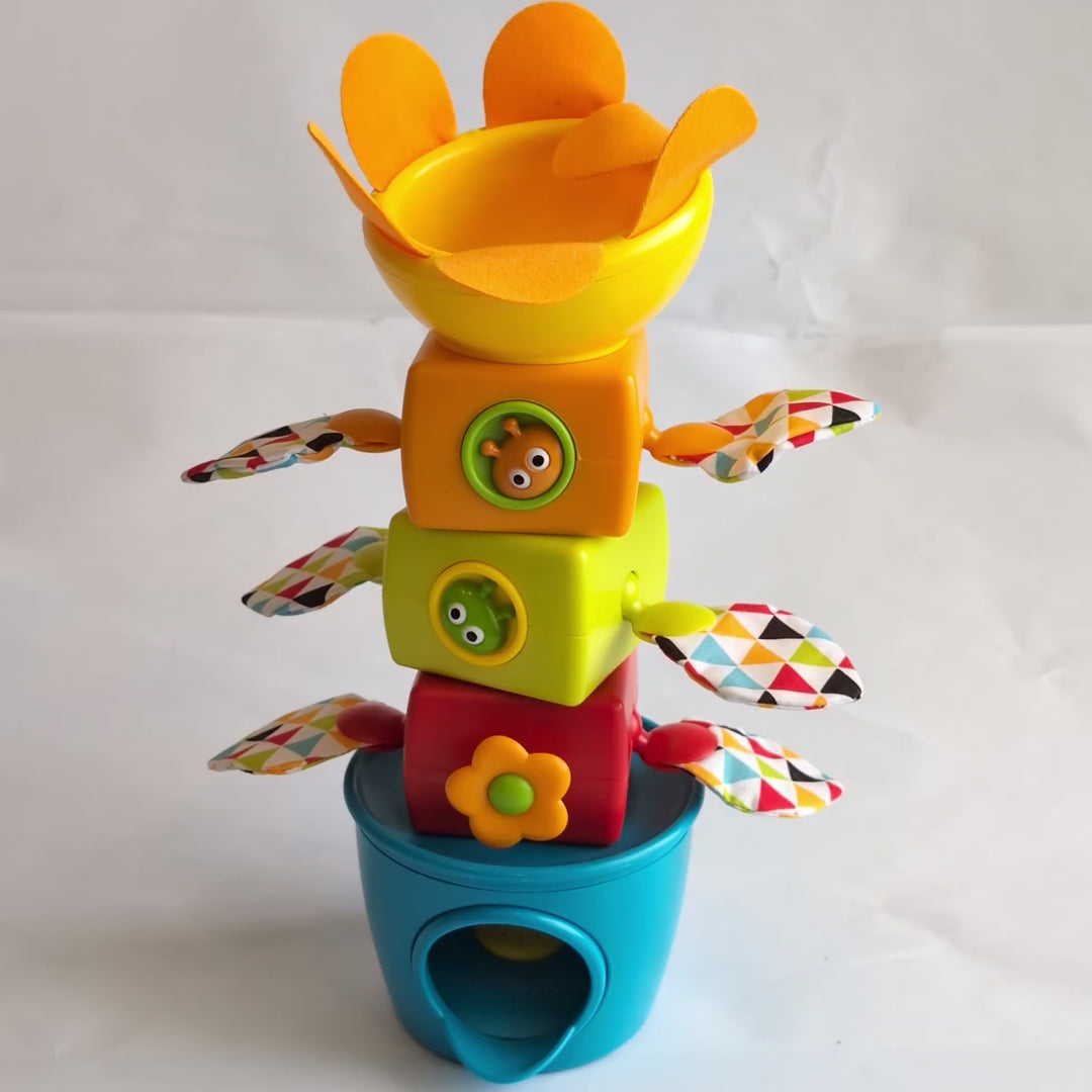 Yookidoo, Tumble Ball Stacker, Cognitive & Motor Skills Development, Five large colorful stackers, each with a gear activity, a flower funnel head with soft petals and crinkly wings, and 3 rattling balls to drop down the center.