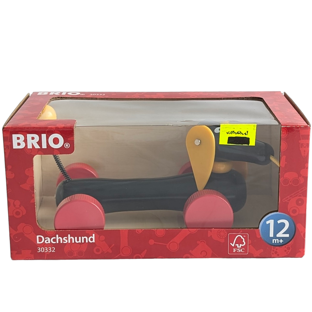 BRIO, Dachshund, Cognitive & Motor Skills Development, The Dachshund pull-along from Brio has been a beloved, classic toy since 1953 and a perfect playmate for today's toddler. The bright, vibrant colors appeal to young children. This dashing dog always keeps up. As it is pulled along the head turns, the ears move and the tail wags. The bright red wheels work on any floor surface. Handcrafted to the exacting quality standards you'd expect from Brio, this durable, wooden playroom heirloom will be enjoyed for