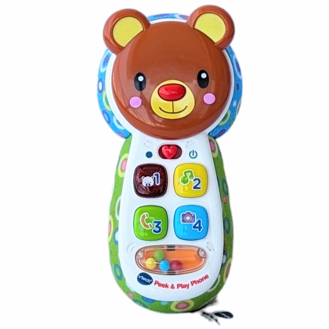 VTech, Baby Peek-A-Bear Baby Phone, Sensory & Language Development, With the Peek-a-Bear Baby Phone™ by VTech®, your little one will have a phone to call their very own. Have fun pretending to make calls by pressing the buttons and hearing playful songs, phrases and music. The colorful buttons introduce colors and numbers, and the heart button lights up. Turn the pink bear's head for a fun surprise—a hidden baby-safe mirror for peek-a-boo fun! The phone attaches to infant seats, strollers and car seats for 