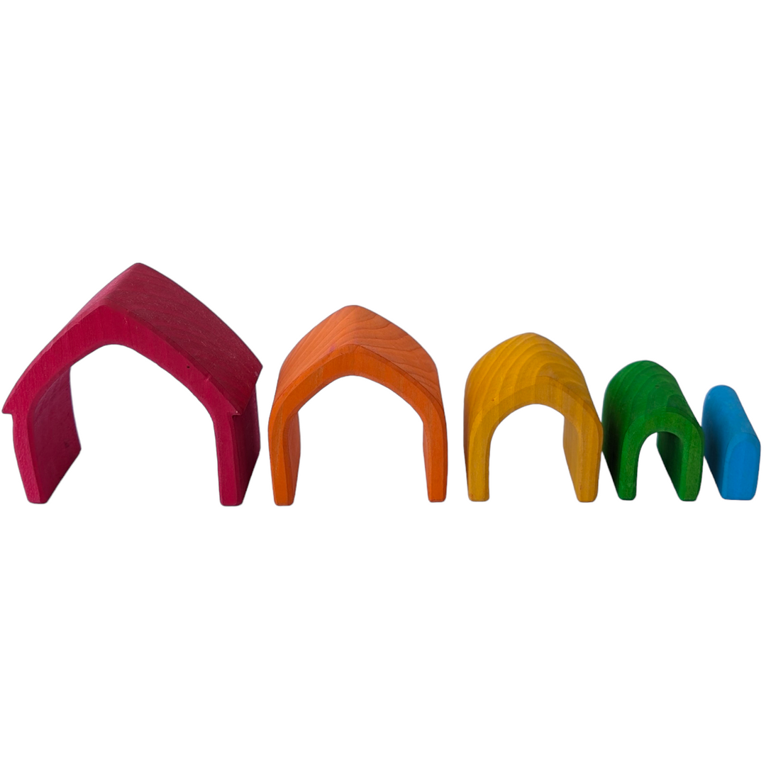 Grimms, Rainbow House, Creative & Imaginative Play, This gorgeous wooden house set will become a firm favourite in your playroom. It comprises 5 little houses, each a different shade of the rainbow, carved from a single piece of lime wood and naturally stained using non-toxic, water-based colour.  This natural finish allows the grain of the wood to shine through and ensures that these house blocks are safe for young children.

Split them up and make fairy doors, tunnels for cars and pens for farm animals;