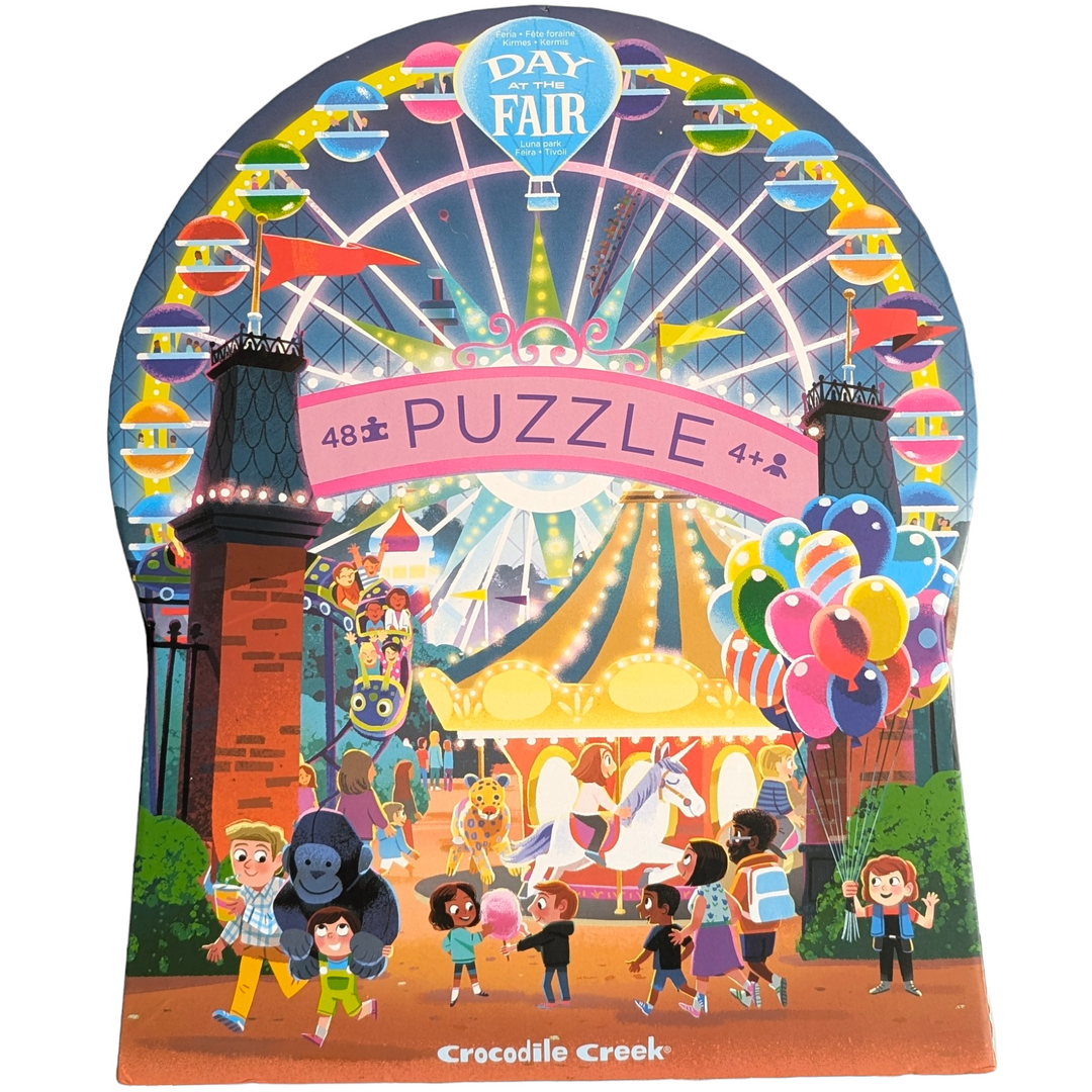 Crocodile Creek, Day at the fair - 48 Pieces, Crocodile Creek's Day at the Fair 48 piece puzzle will transport you to a fun, whimsical evening at the fair! This observation puzzle features lots of strange and humourous things that are happening at the fair or amusement park. Richly detailed puzzle is 18" x 24" when complete. The uniquely shaped packaging makes storing this puzzle even more fun. All Crocodile Creek's puzzles are printed with soy-based ink on recycled cardboard.