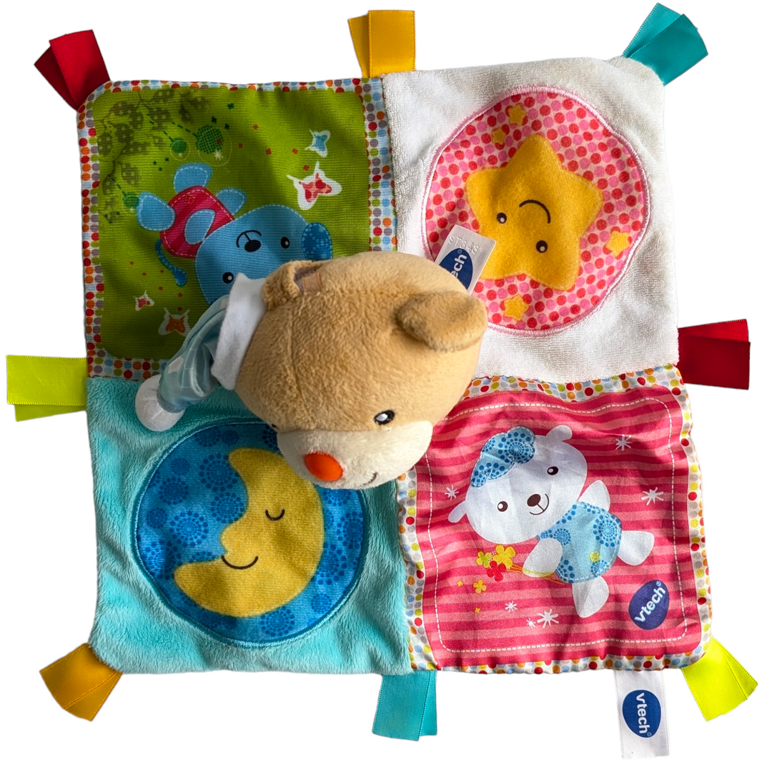 Vtech, Soothing Songs Lovey Blanket Bear, Sensory & Language Development , A snuggle is all that the VTech® Calm Songs LoveyTM is waiting for! For your infant, this cuddly and charming bear is the ideal friend. Little ones can feel protected and at ease with its vibrant design and soft materials and ribbons. Squeezing the bear's ear will allow your infant to hear charming sentences and calming music. The detachable electronics make it simple to care for the blanket.