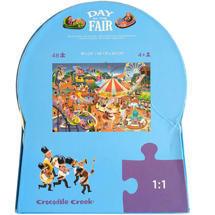 Crocodile Creek, Day at the fair - 48 Pieces, Crocodile Creek's Day at the Fair 48 piece puzzle will transport you to a fun, whimsical evening at the fair! This observation puzzle features lots of strange and humourous things that are happening at the fair or amusement park. Richly detailed puzzle is 18" x 24" when complete. The uniquely shaped packaging makes storing this puzzle even more fun. All Crocodile Creek's puzzles are printed with soy-based ink on recycled cardboard.