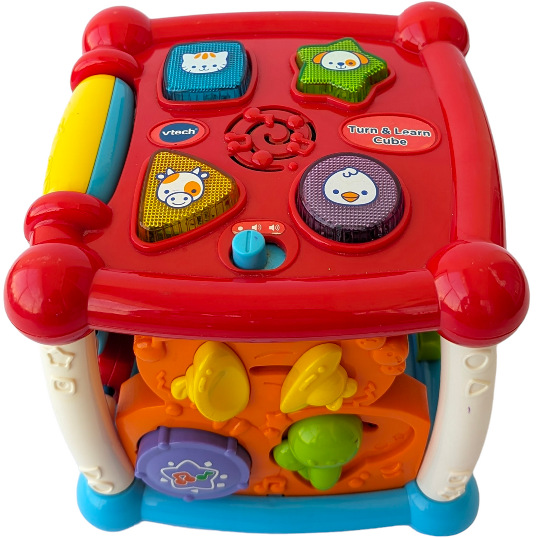 VTech, Turn and Learn Cube, Sensory & Language Development, Exploration and fun is around every corner with the Busy Learner’s Activity Cube™ by VTech®. Featuring five sides to explore, this play cube attracts your baby’s attention and encourages imaginative play with music, light-up buttons, colors and more. Shape and animal buttons introduce animal names, animal sounds and shapes. Press and slide musical instrument buttons introduce instrument names, sounds and colors.