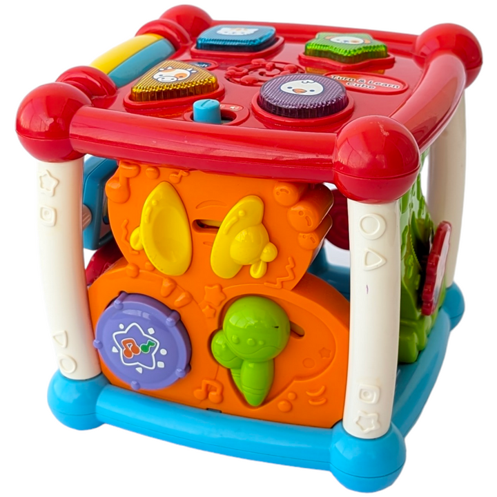 VTech, Turn and Learn Cube, Sensory & Language Development, Exploration and fun is around every corner with the Busy Learner’s Activity Cube™ by VTech®. Featuring five sides to explore, this play cube attracts your baby’s attention and encourages imaginative play with music, light-up buttons, colors and more. Shape and animal buttons introduce animal names, animal sounds and shapes. Press and slide musical instrument buttons introduce instrument names, sounds and colors.