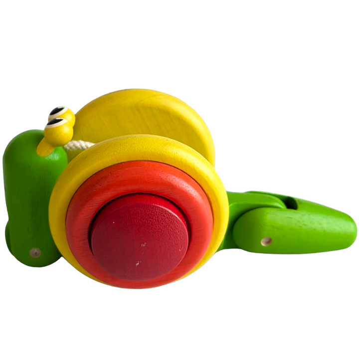 PlanToys, Pull Along Snail, Cognitive & Motor Skills, The tug-along Snail crawls and inches across the floor when kids tug on it. This toy promotes coordination, fine motor, and gross motor skill development. Children who practise walking and exploring independently while pushing the snail along strengthen their balance and coordination. The body of the snail crawls forward as it is dragged along, rolling over the shell's margins. Engaging in more hands-on play with the snail improves fine motor abilities