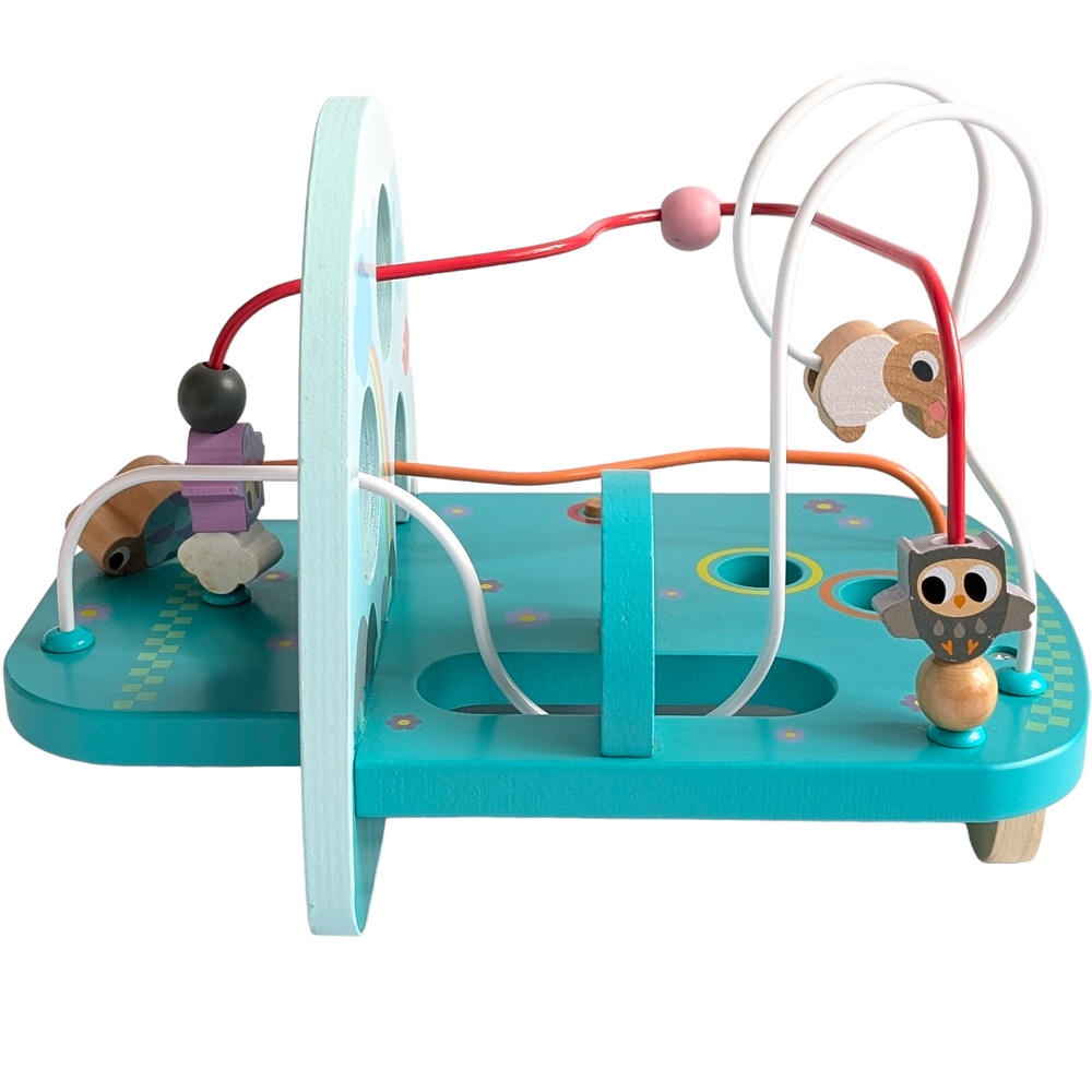 Janod, Looping Lapin & Cie, Rabbit & Co Looping, Cognitive & Motor Skills Development, Introducing a pretty looping toy that will arouse baby's curiosity from 18 months onwards. The animal-shaped beads and the attractive colours on this wooden looping game, are ideal for developing fine motor skills and guarantee many an hour of play. Your child will be able to slide the beads across the mountain, have fun slotting the 2 carrots into the earth and reassemble a small tomato-shaped stacking toy. 