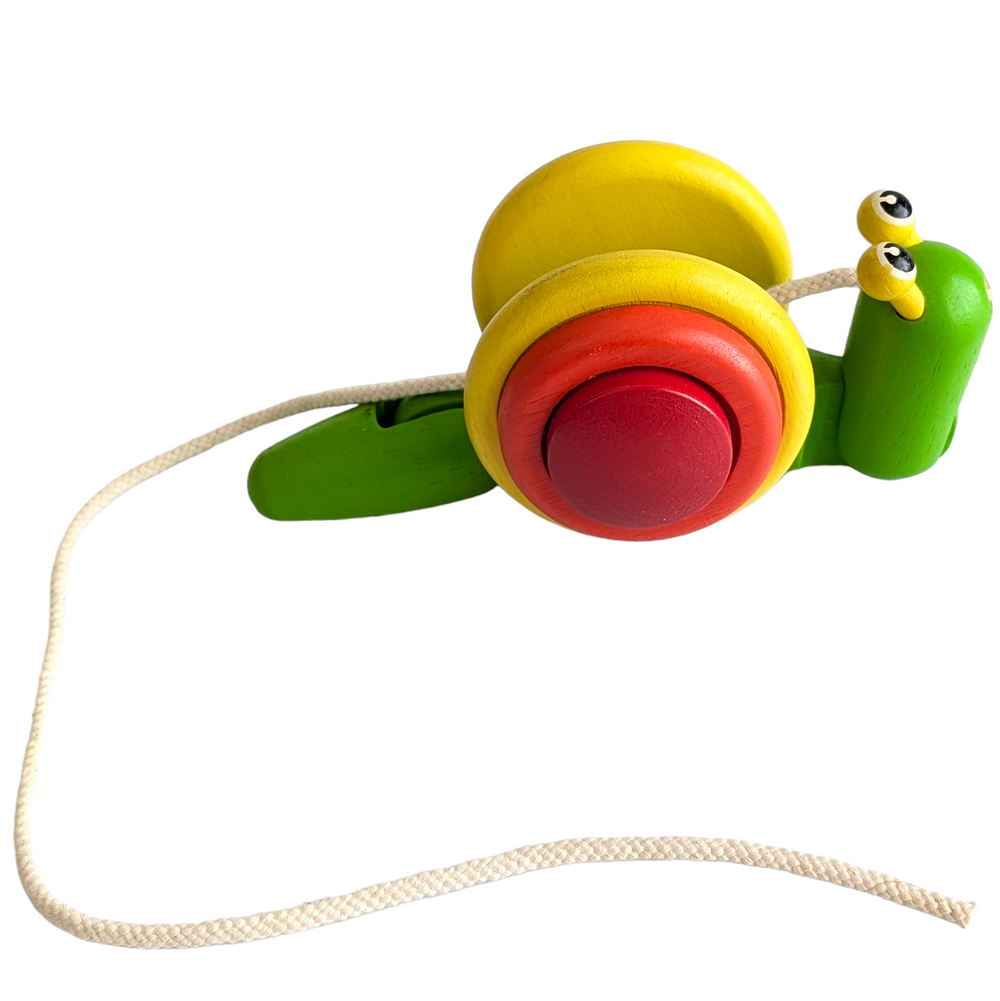 PlanToys, Pull Along Snail, Cognitive & Motor Skills, The tug-along Snail crawls and inches across the floor when kids tug on it. This toy promotes coordination, fine motor, and gross motor skill development. Children who practise walking and exploring independently while pushing the snail along strengthen their balance and coordination. The body of the snail crawls forward as it is dragged along, rolling over the shell's margins. Engaging in more hands-on play with the snail improves fine motor abilities